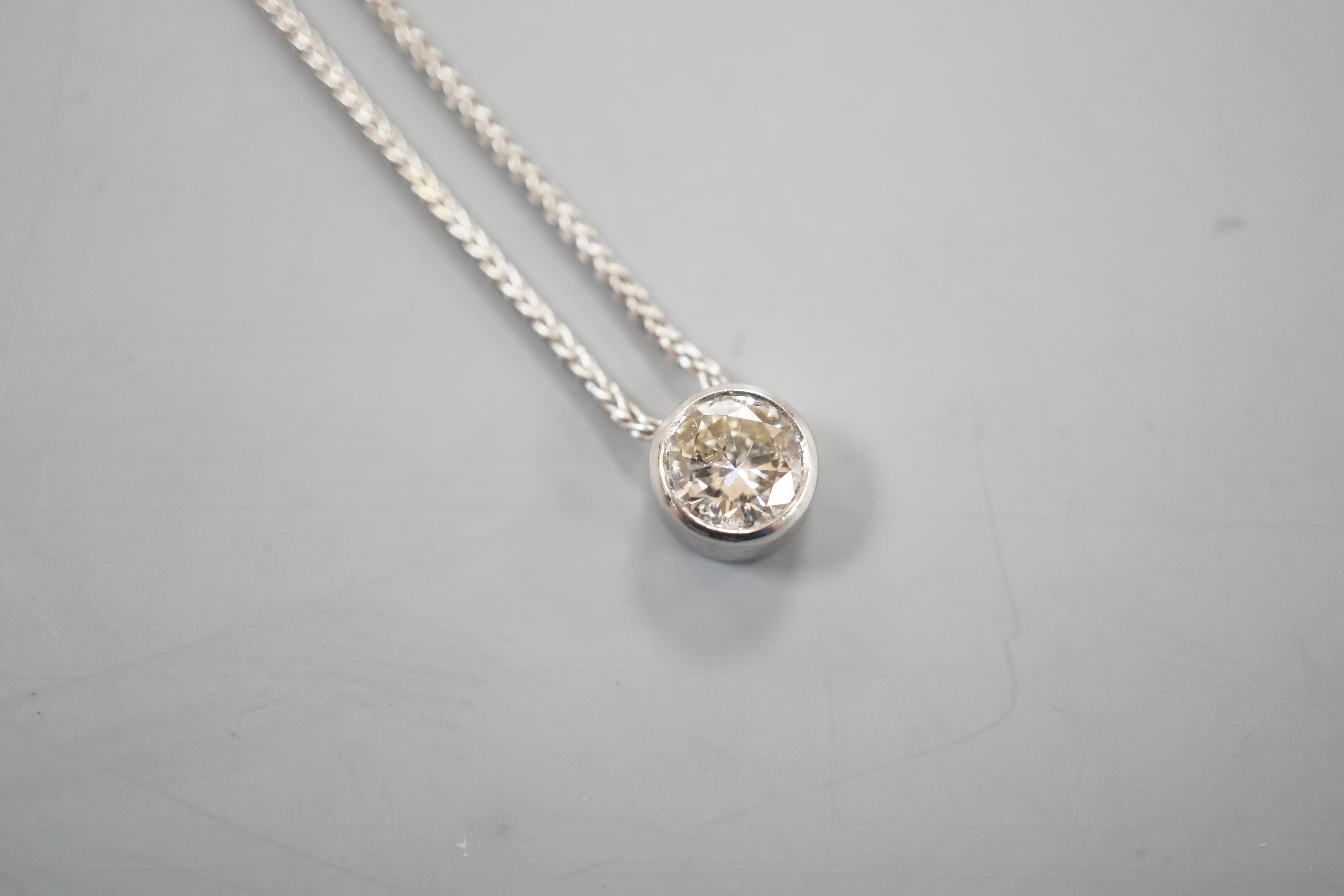 A modern Italian 18ct white gold and collet set solitaire diamond pendant necklace, 38cm, gross weight 3.8 grams